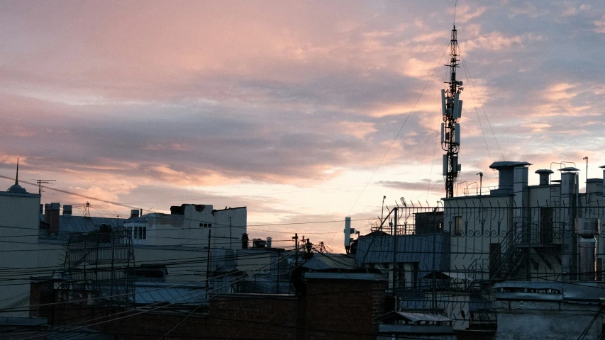 a city is lit by a pink sky as the sun rises