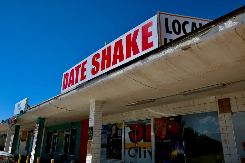 the sign says bite shake local on a storefront