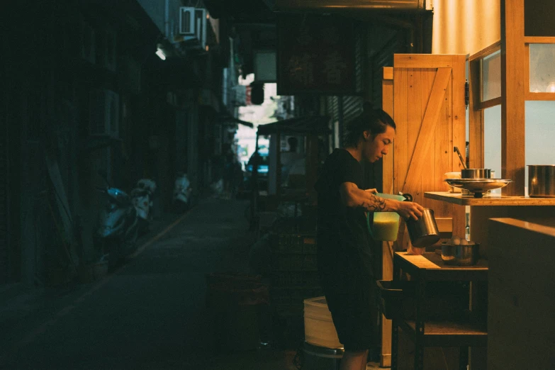 a woman holding a container is working on her computer