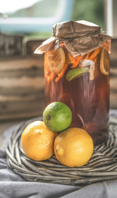 a jar filled with fruit sitting on top of a table