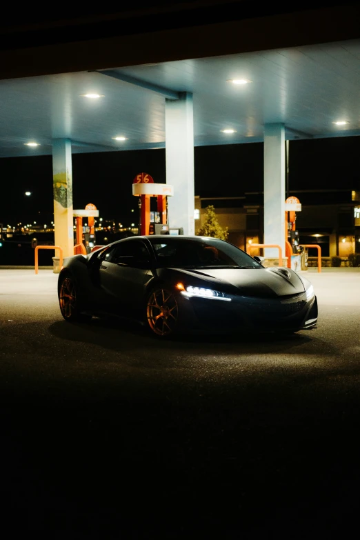 a black sports car sitting on the street