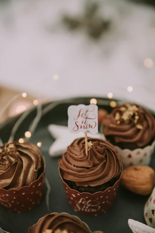 the cupcakes are decorated with chocolate frosting