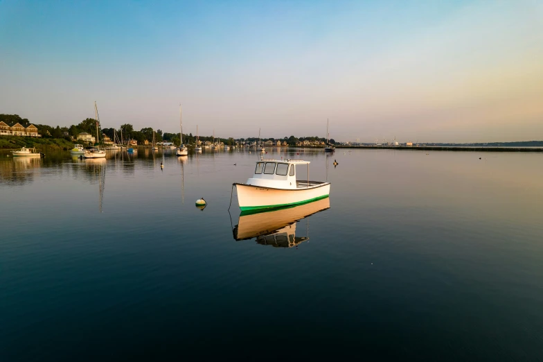 there is a small boat floating in the lake