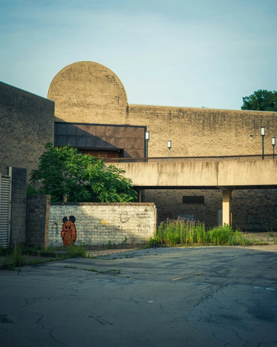 a building sitting across from a parking lot with a wall around it