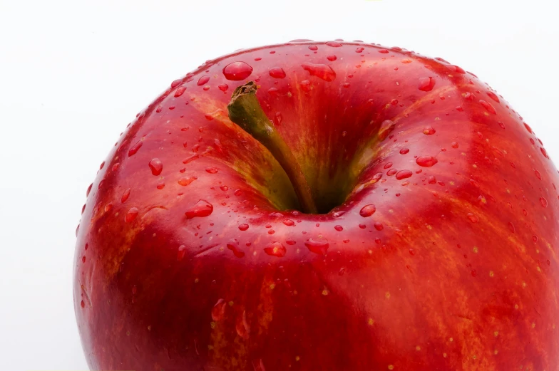 a red apple sitting on top of a table