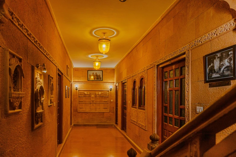 a hallway with many framed pos and wooden trim