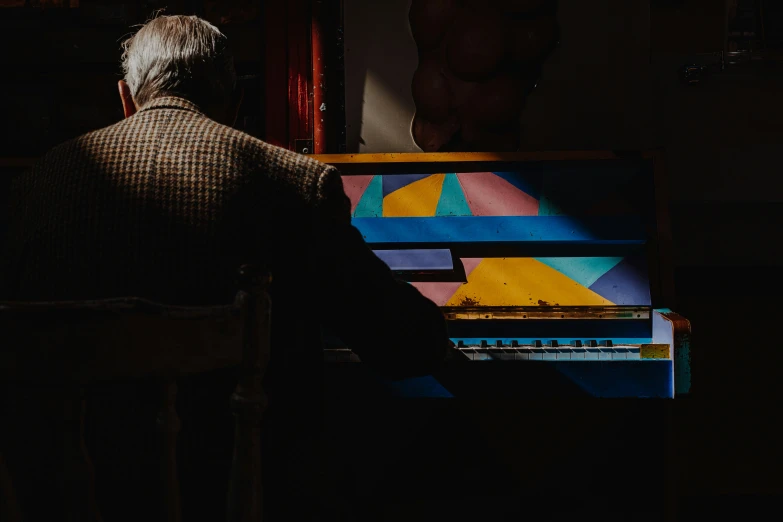 a man playing piano outside in the dark