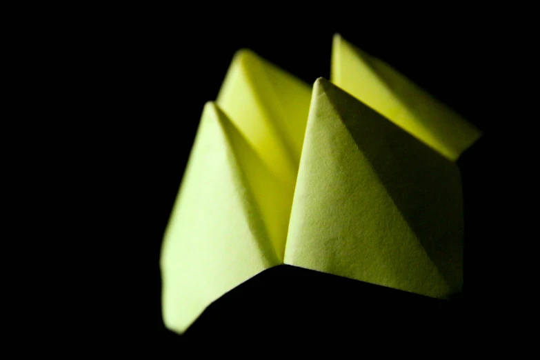 an abstract image of folded objects in the dark