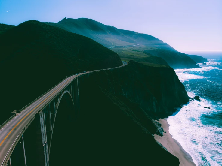 an elevated view looking down at the ocean and mountain