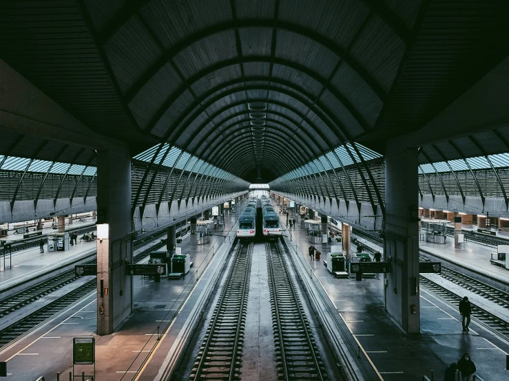 a train station with a car and several tracks