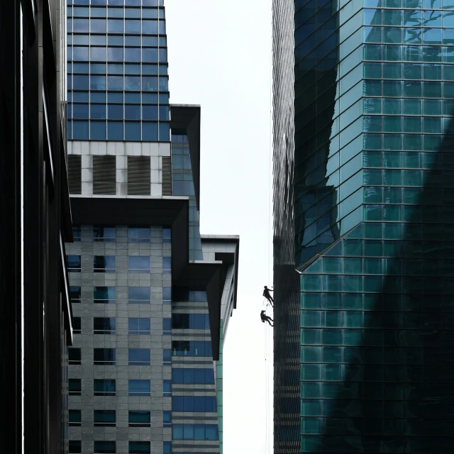 a view of several buildings that are connected by two tall building