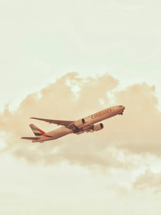 the plane is in mid flight near some clouds