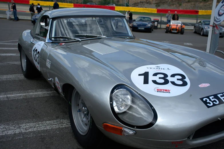 a vintage car with a number on it in the parking lot