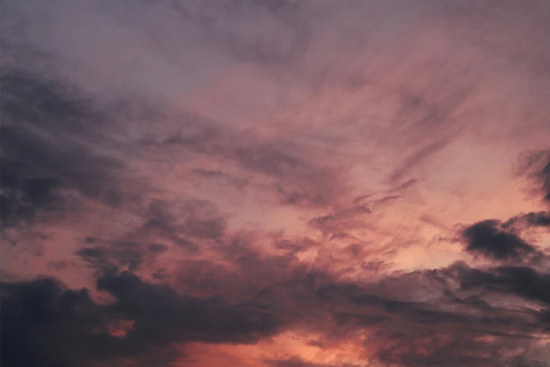 a dark sky with clouds during the day