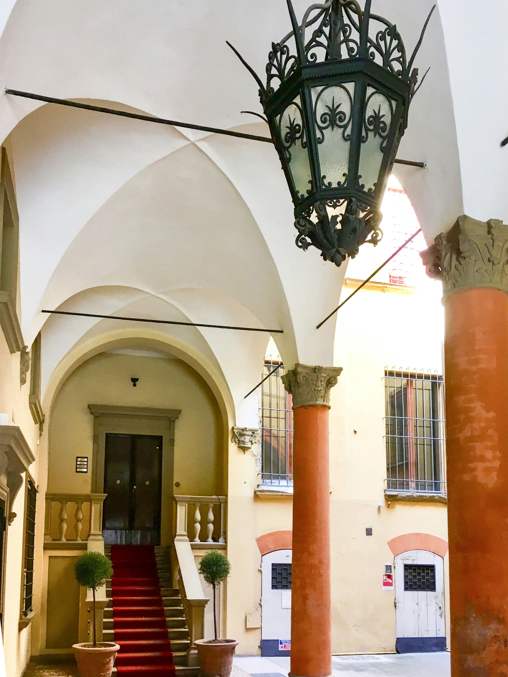 a large hallway with a light hanging from it's ceiling