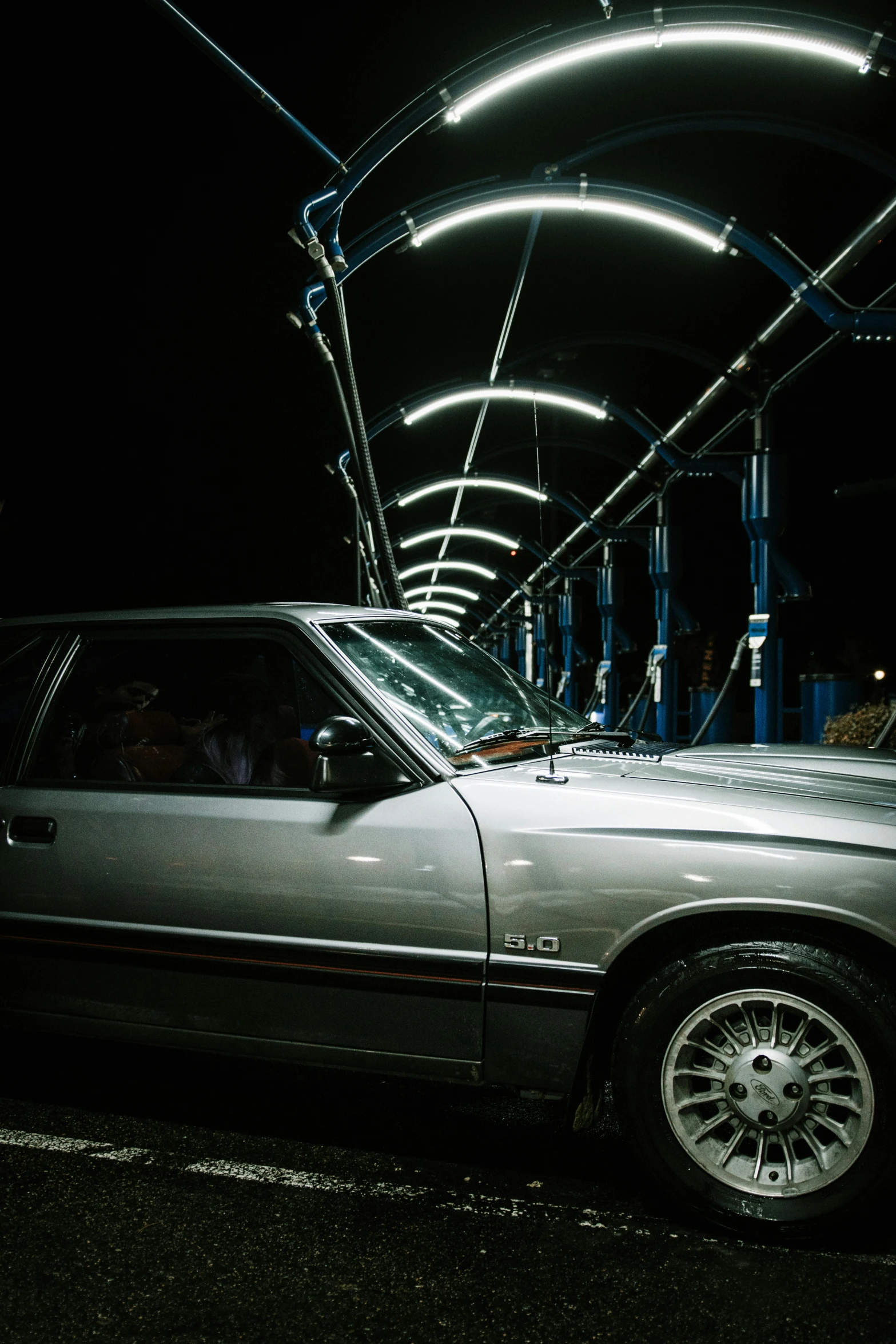 a car that is parked under some lights