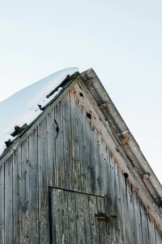 a barn is covered in snow and has no roof