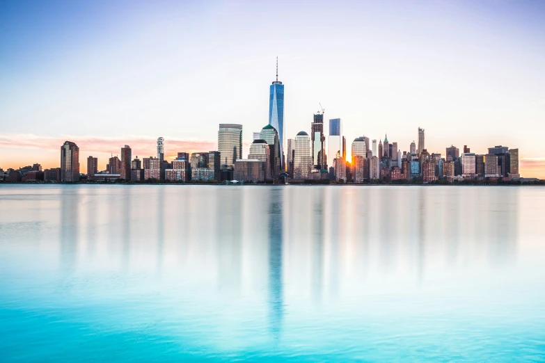 a city sits on a calm river in the distance