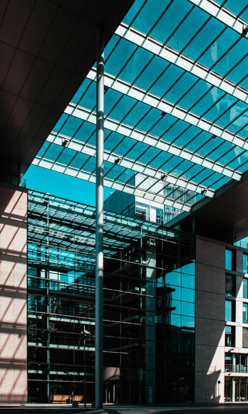 a building's glass roof is shining brightly in the sun