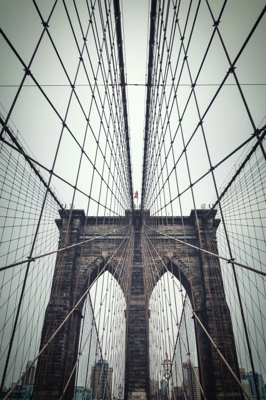 an image of a large suspension bridge in a gray sky
