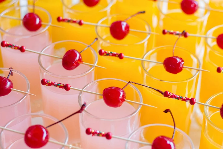 rows of plastic cups filled with fruit on metal rods