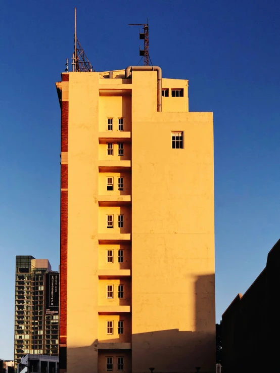 building with sky in the background with skyscr next to it