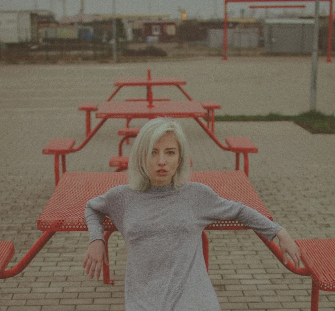 a woman sitting on a bench with her arms outstretched