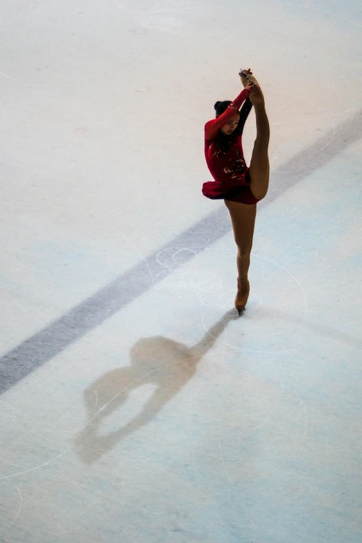 a woman in a red leotard is skating