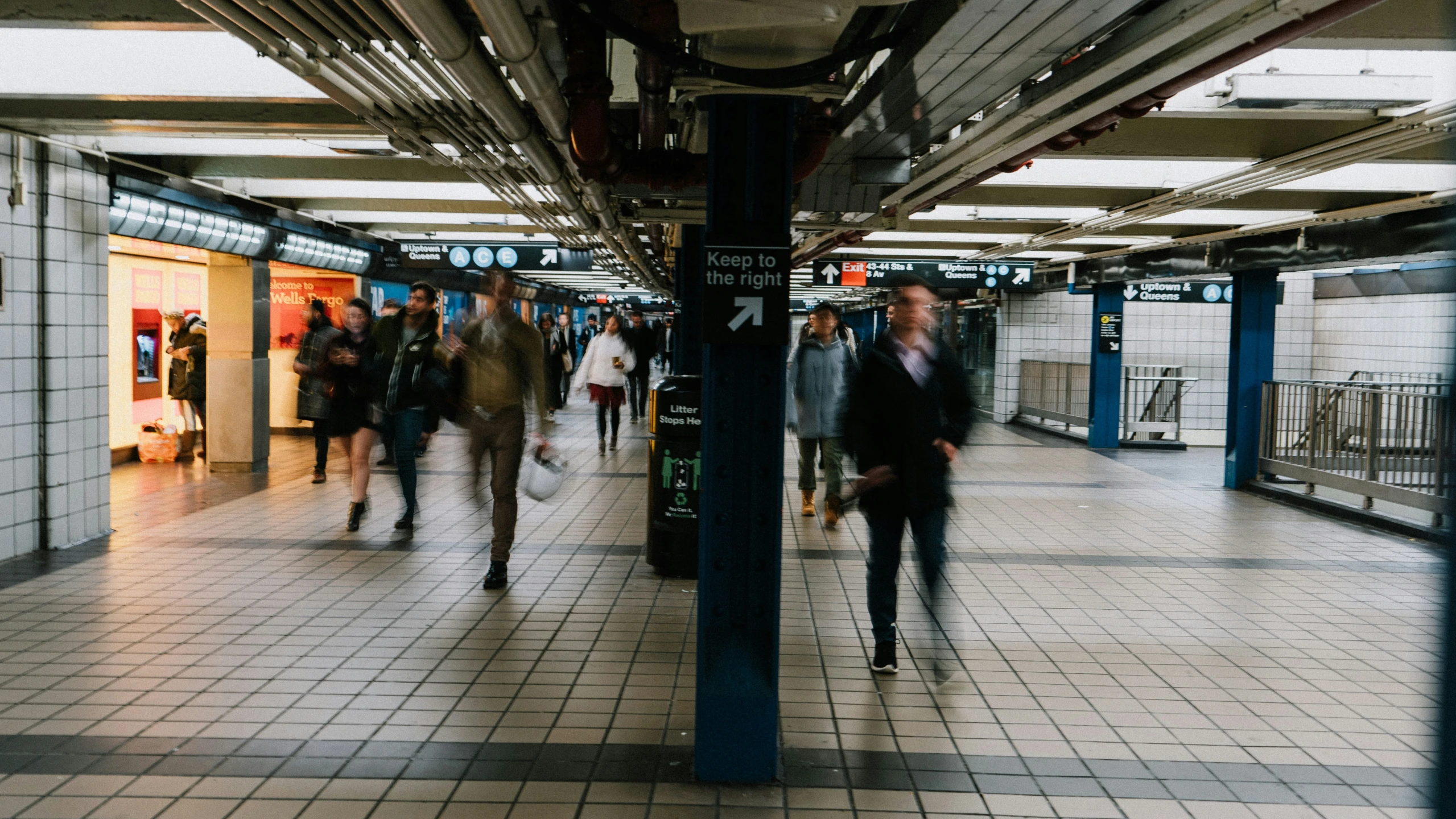 there are many people walking in the subway