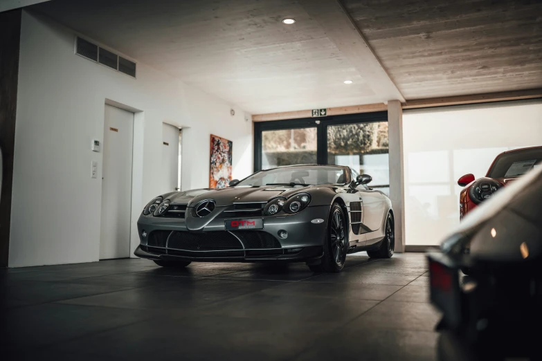 two cars parked in a garage next to one another