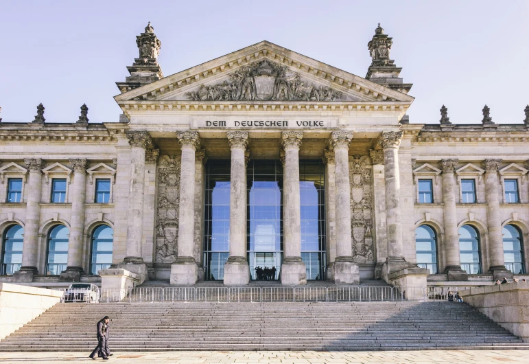 an old building has steps and a person standing in front of it