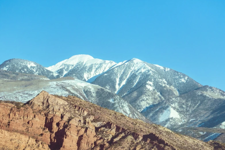 mountains covered in snow with blue sky above