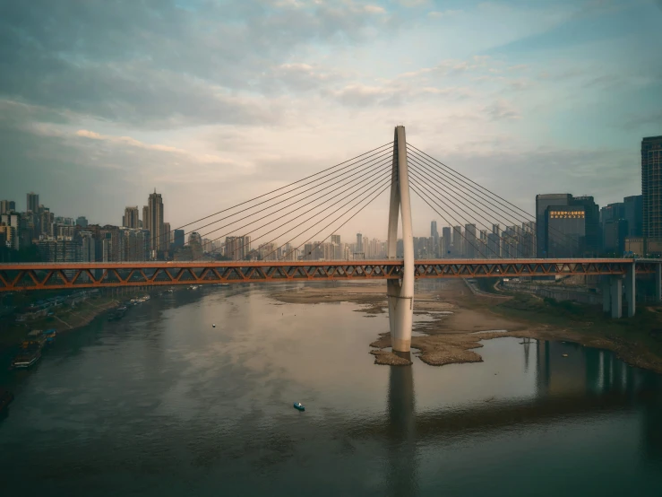 a very tall bridge with buildings in the background