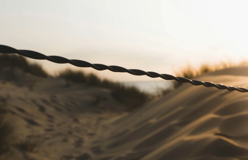 a close up s of a fence and some sand