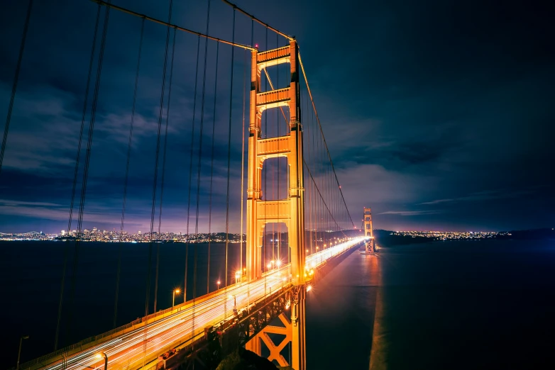 there is a long, straight picture of an illuminated bridge