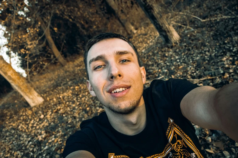 man with black shirt and his arm up smiling