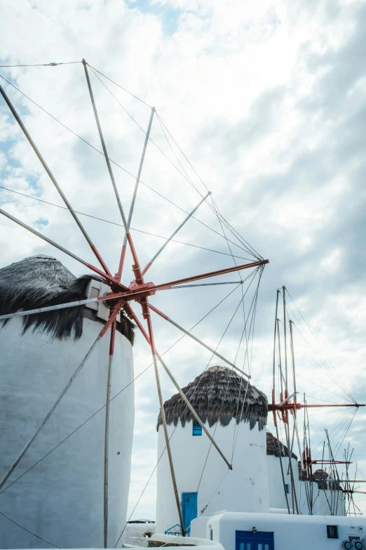 windmills on the roof of an old windmill with white painted walls