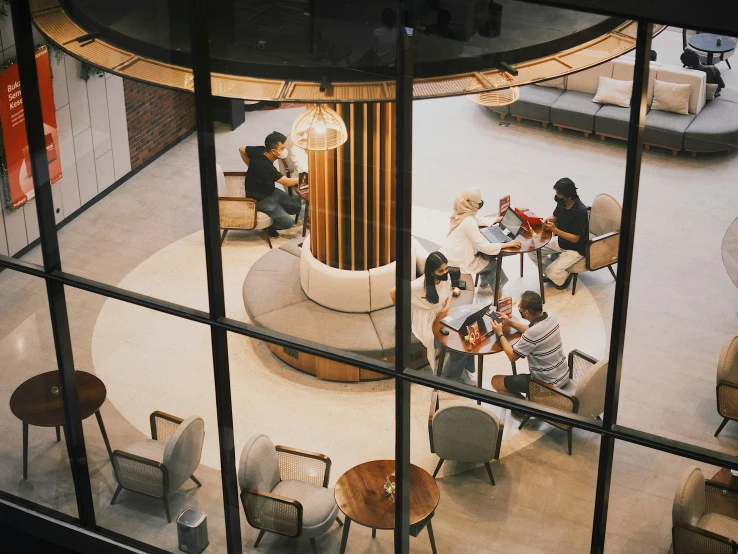 the view of the inside of a restaurant with several people eating