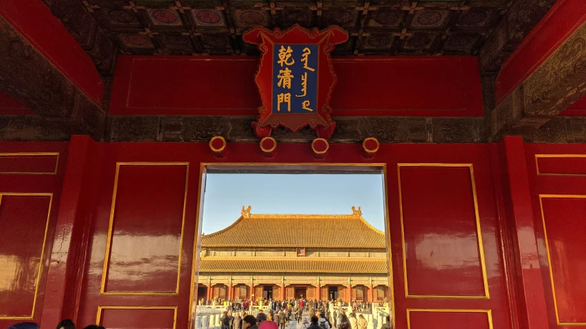 people in a temple with a reflection of the building