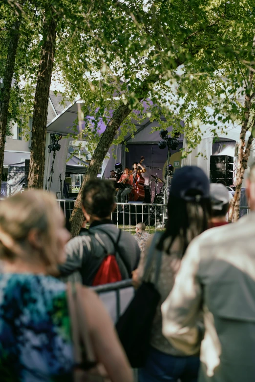 a band in a park performing on stage