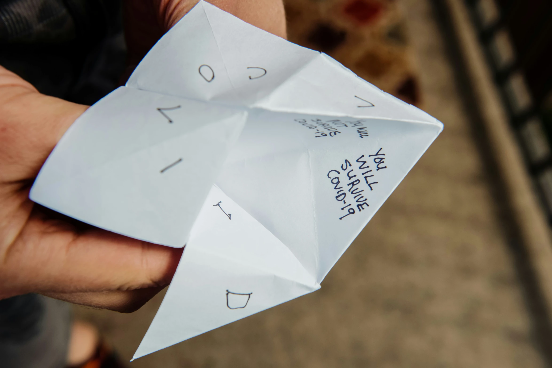 someone holding an origami shaped paper item in their hand