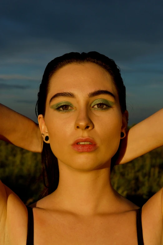 a woman in an open field posing for a picture