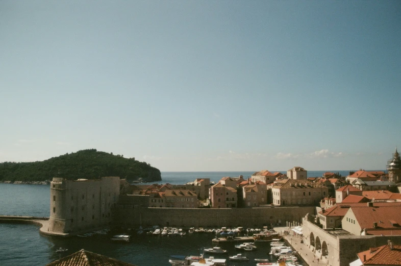 a view over the water to an island and buildings