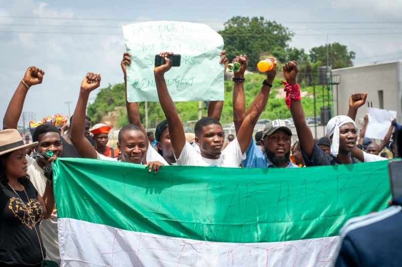 a large crowd of people holding up their hands