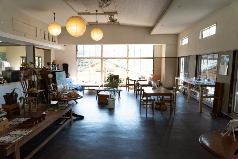 a store is empty with several wood tables and chairs