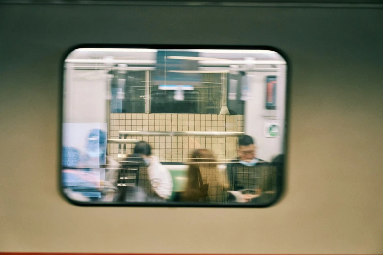 some people and trains are inside a small window