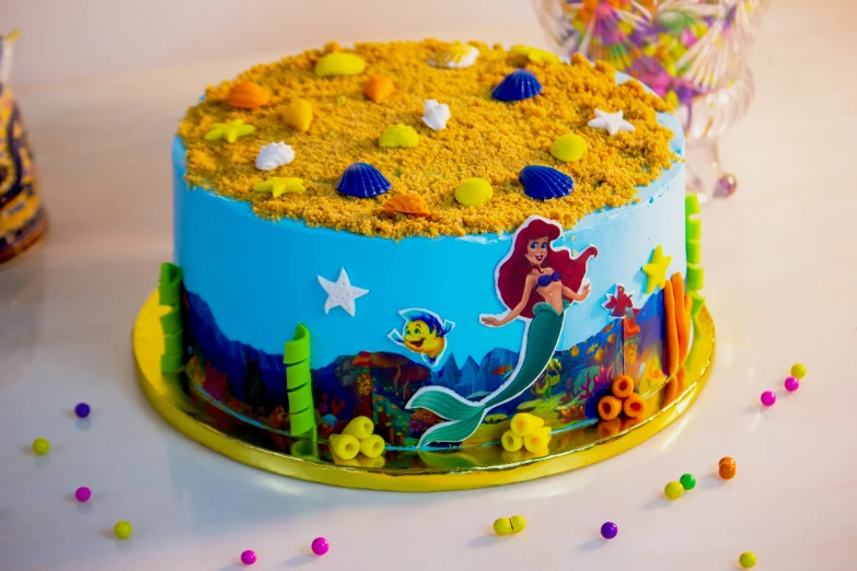 there is a birthday cake with the little mermaid on it
