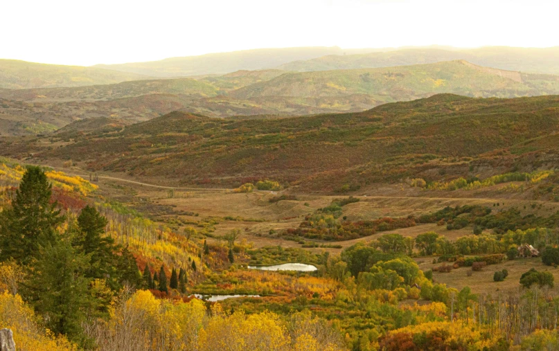 a scenic view of a mountainside in the autumn