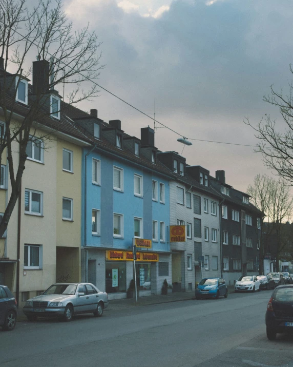 many cars parked on the side of the street