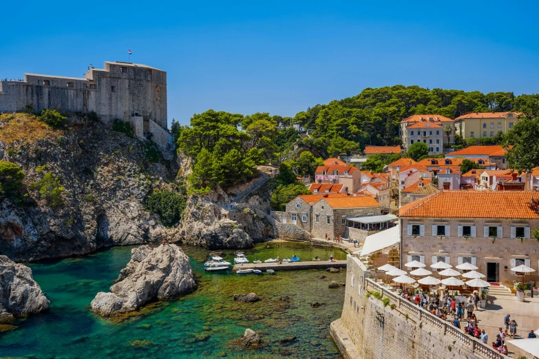 a castle by the water with people on it